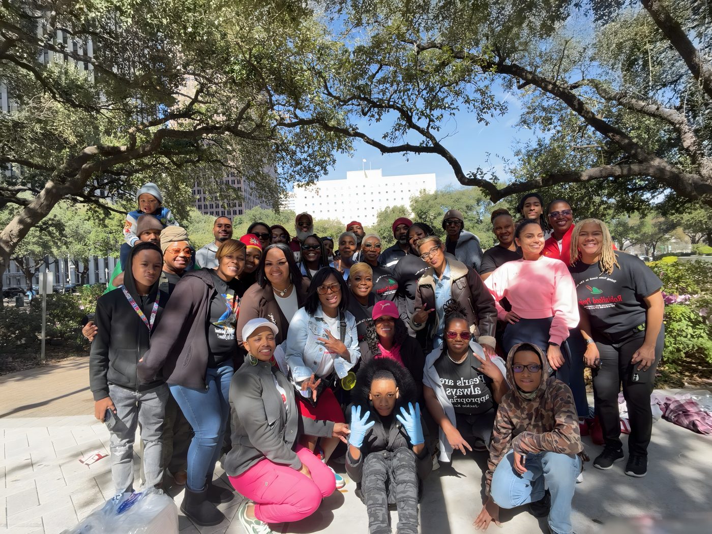 The Robin Hood Project crew together under the oaks by Houston City Hall