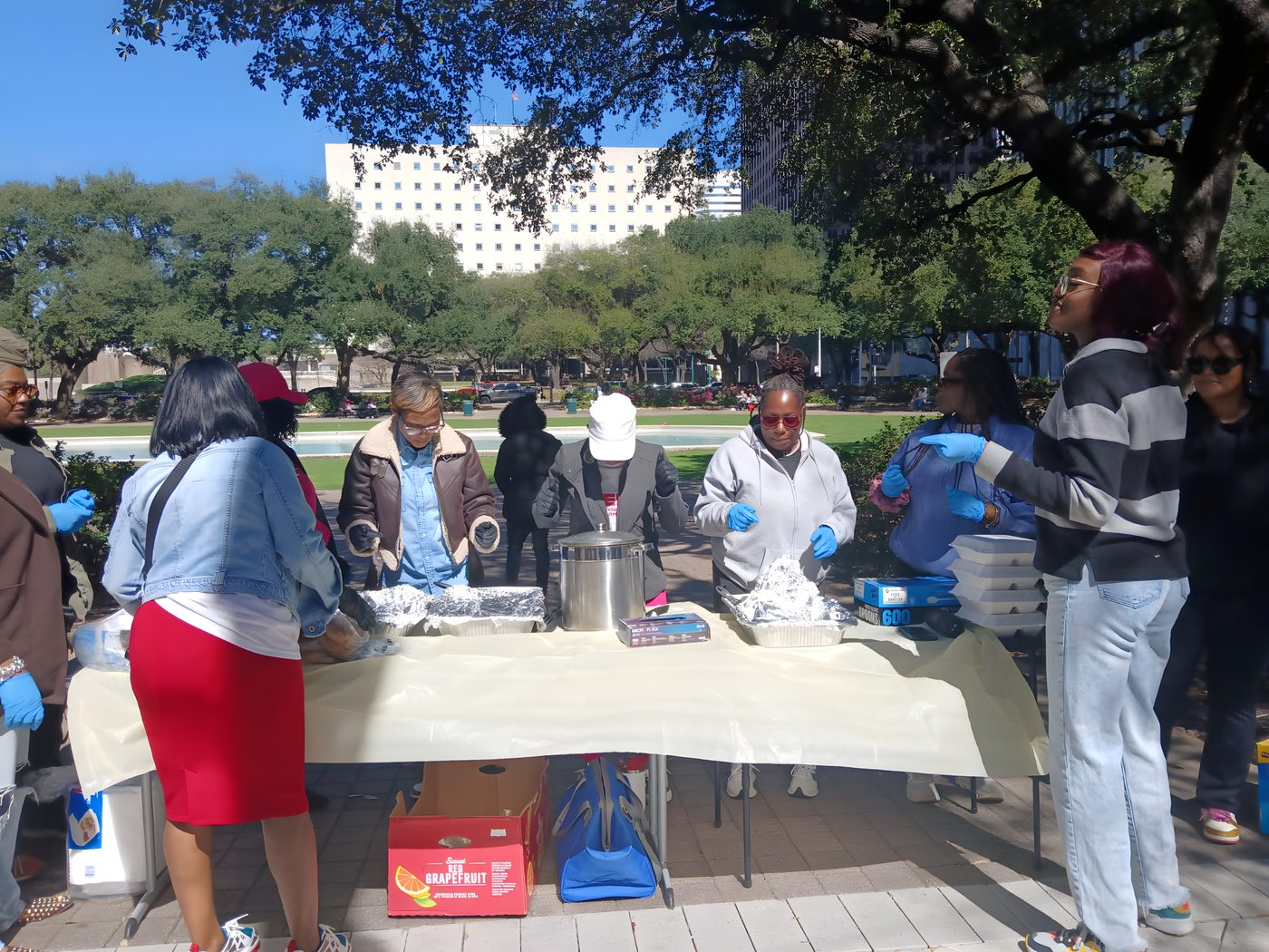 Volunteers serving hot meals at our outdoor table